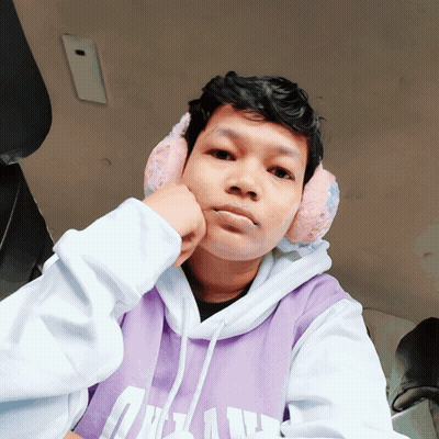 A Young Man Wearing Ear Muffs And A Purple Hoodie With The Letter U On It GIF