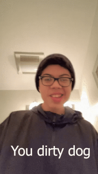 A Young Man Wearing Glasses And A Beanie Says " You Dirty Dog " GIF