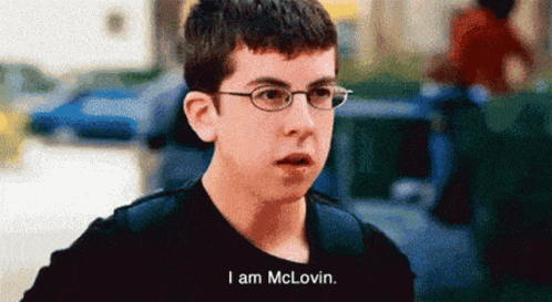 A Young Man Wearing Glasses And A Black Shirt Says I Am Mclovin GIF