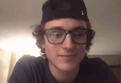 A Young Man Wearing Glasses And A Hat Has The Letter J On His Hat GIF