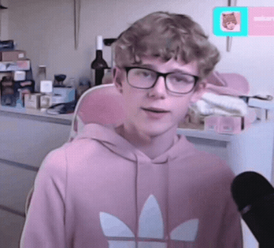 A Young Man Wearing Glasses And A Pink Adidas Sweatshirt GIF