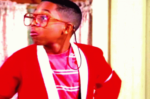 A Young Man Wearing Glasses And A Red Jacket Looks Surprised GIF