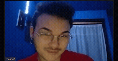 A Young Man Wearing Glasses And A Red Shirt Is Making A Funny Face . GIF