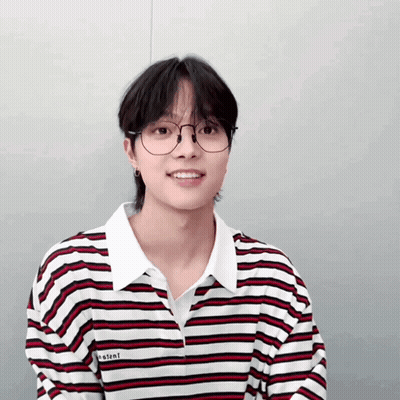 A Young Man Wearing Glasses And A Striped Shirt With The Word Instant On It GIF