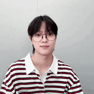 A Young Man Wearing Glasses And A Striped Shirt With The Word Vincent On The Front GIF