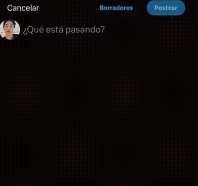 A Young Man Wearing Glasses And A White Jacket Is Looking At A Cell Phone . GIF
