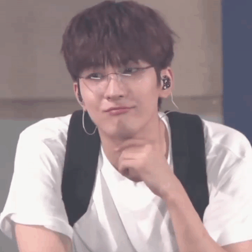 A Young Man Wearing Glasses And Ear Buds Is Making A Funny Face GIF