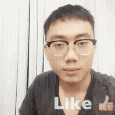 A Young Man Wearing Glasses Is Giving A Thumbs Up Sign . GIF