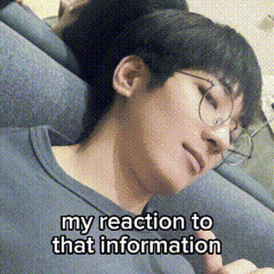 A Young Man Wearing Glasses Is Laying On A Couch With His Eyes Closed . GIF