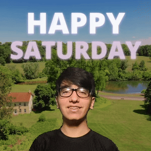 A Young Man Wearing Glasses Is Standing In Front Of A Happy Saturday Sign GIF