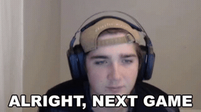 A Young Man Wearing Headphones And A Baseball Cap Is Sitting In Front Of A Computer Screen . GIF