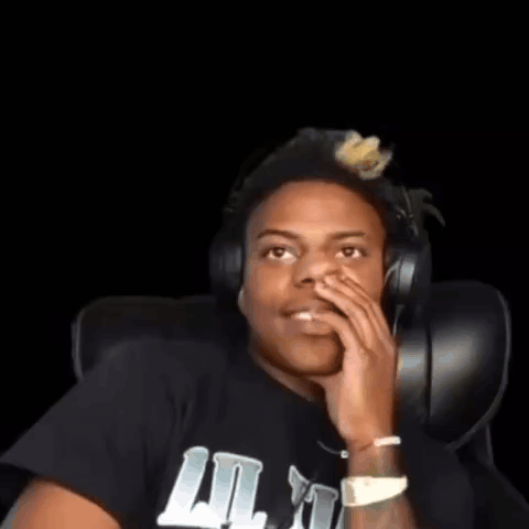 A Young Man Wearing Headphones And A Black Shirt Is Sitting In A Chair . GIF