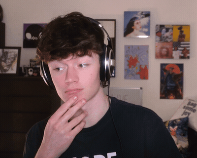 A Young Man Wearing Headphones And A Black Shirt That Says Mode GIF