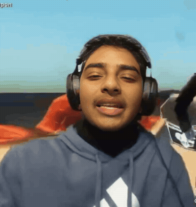 A Young Man Wearing Headphones And A Blue Adidas Shirt GIF