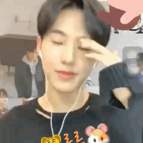 A Young Man Wearing Headphones And A Hamster Necklace Is Crying . GIF