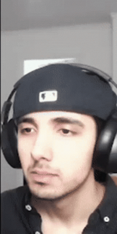 A Young Man Wearing Headphones And A Hat . GIF