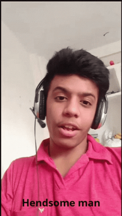 A Young Man Wearing Headphones And A Pink Shirt With The Words Handsome Man Below Him GIF