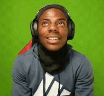 A Young Man Wearing Headphones And A Scarf Around His Neck Is Smiling . GIF