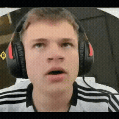 A Young Man Wearing Headphones Is Making A Surprised Face GIF