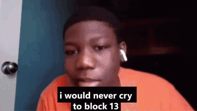 A Young Man Wearing Headphones Is Sitting In Front Of A Door . GIF