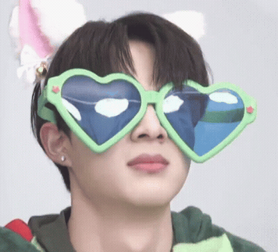 A Young Man Wearing Heart Shaped Sunglasses And A Cat Ear Headband . GIF