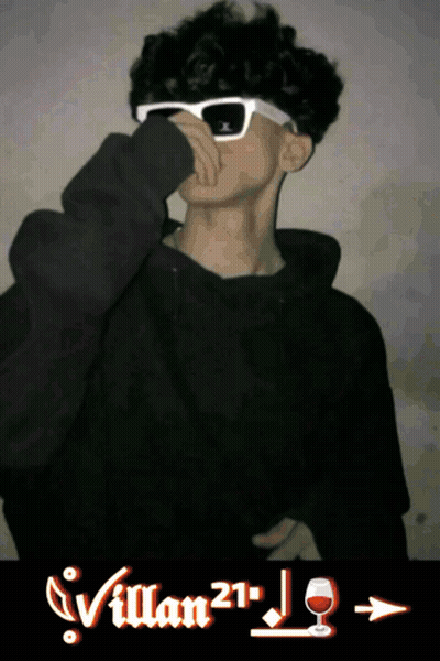 A Young Man Wearing Sunglasses And A Black Hoodie With Villan21 Written On The Bottom GIF