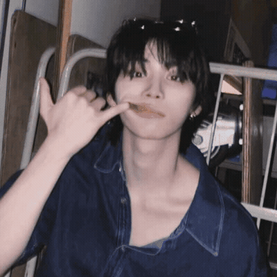 A Young Man Wearing Sunglasses And A Blue Shirt Is Making A Phone Call Sign GIF
