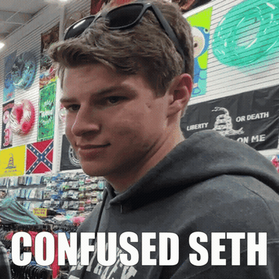 A Young Man Wearing Sunglasses And A Sweatshirt That Says Confused Seth Looks At The Camera GIF