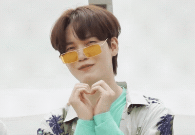 A Young Man Wearing Yellow Sunglasses Makes A Heart Shape With His Hands GIF