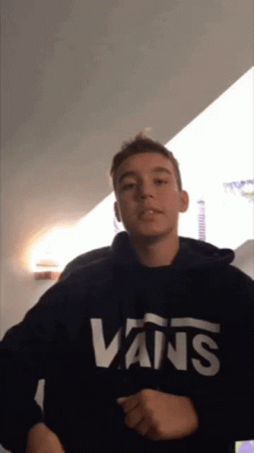 A Young Man Wears A Black Vans Sweatshirt GIF
