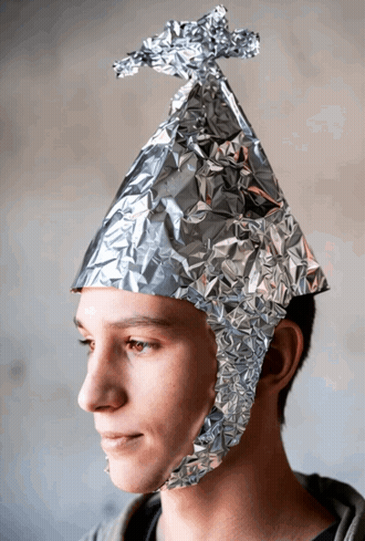 A Young Man Wears A Hat Made Of Aluminum Foil GIF