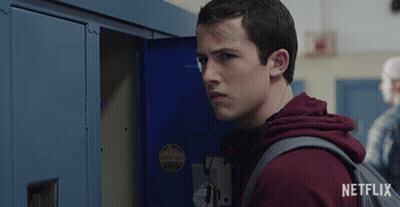 A Young Man With A Bandage On His Forehead Is Standing In Front Of A Locker That Says Netflix On It GIF