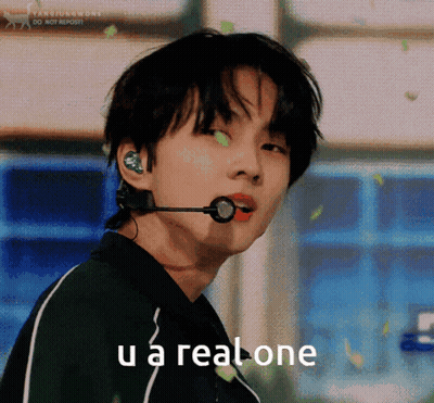 A Young Man With A Microphone In His Ear And The Words U A Real One Below Him GIF