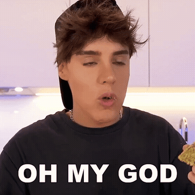 A Young Man With A Piercing In His Lip Is Holding A Piece Of Food With The Words Oh My God Below Him GIF