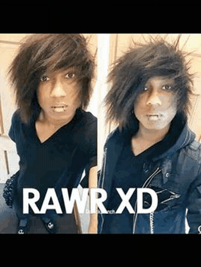 A Young Man With A Piercing In His Lip Is Wearing A Black Shirt And A Black Jacket And Taking A Selfie . GIF
