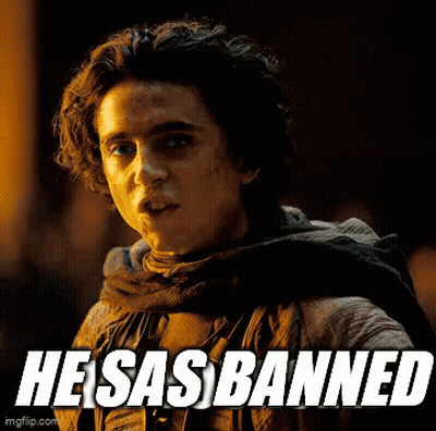 A Young Man With A Scarf Around His Neck And The Words He Sas Banned On The Bottom GIF