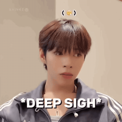 A Young Man With A Smiley Face On His Head Is Wearing A Jacket That Says Deep Sigh GIF