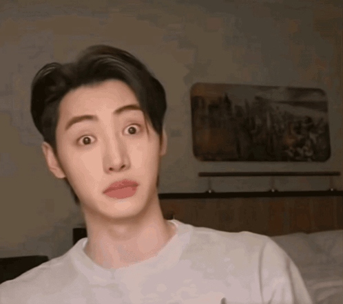 A Young Man With A Surprised Look On His Face Wearing A White Shirt GIF
