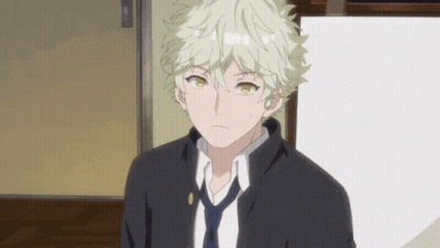 A Young Man With Blonde Hair And A Black Jacket And Tie GIF