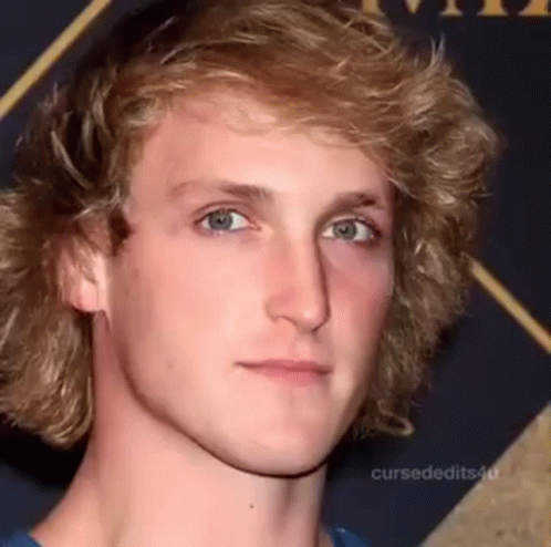 A Young Man With Blonde Hair And Blue Eyes Is Making A Funny Face . GIF