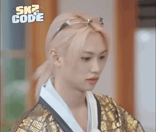 A Young Man With Blonde Hair And Glasses Is Wearing A Kimono And A Ponytail . GIF