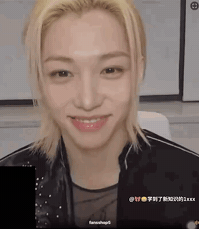 A Young Man With Blonde Hair Is Smiling And Wearing A Black Jacket GIF
