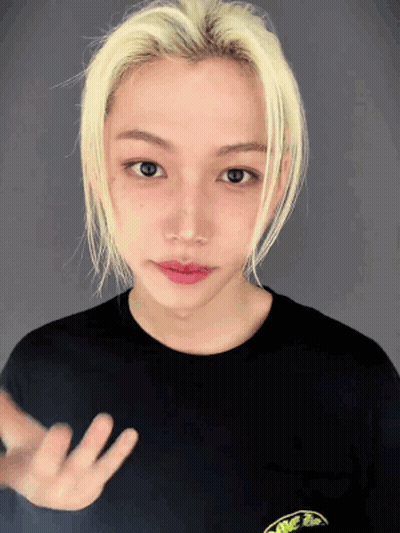 A Young Man With Blonde Hair Is Wearing A Black T-Shirt With A Frog On It GIF