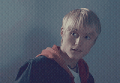 A Young Man With Blonde Hair Wearing A Red Hoodie GIF