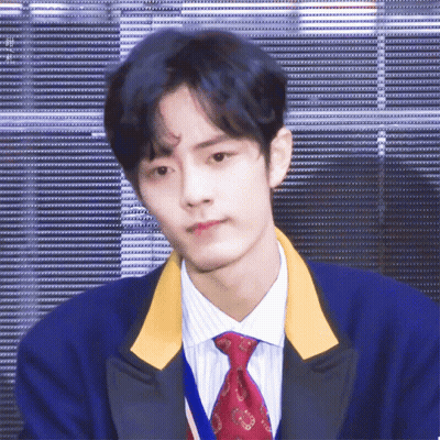 A Young Man With Blue Hair And A Red Tie GIF