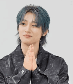 A Young Man With Blue Hair Is Holding His Hands Together In Prayer . GIF
