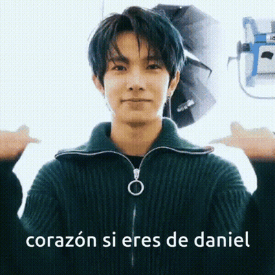 A Young Man With Blue Hair Is Wearing A Green Sweater And Making A Thumbs Up Sign . GIF