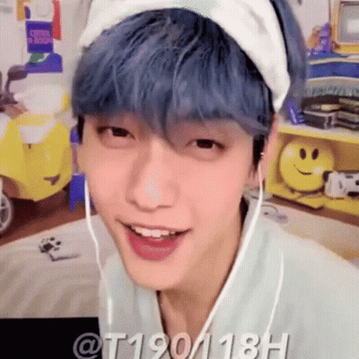 A Young Man With Blue Hair Is Wearing A Headband And Headphones . GIF