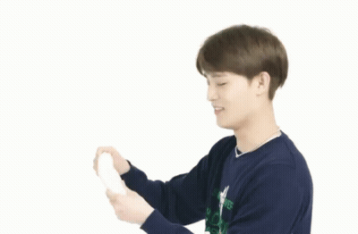 A Young Man With Brown Hair Is Smiling And Wearing A Necklace . GIF