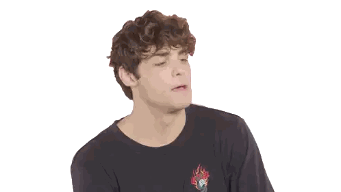 A Young Man With Curly Hair Is Wearing A Black T-Shirt With A Skull On It Sticker